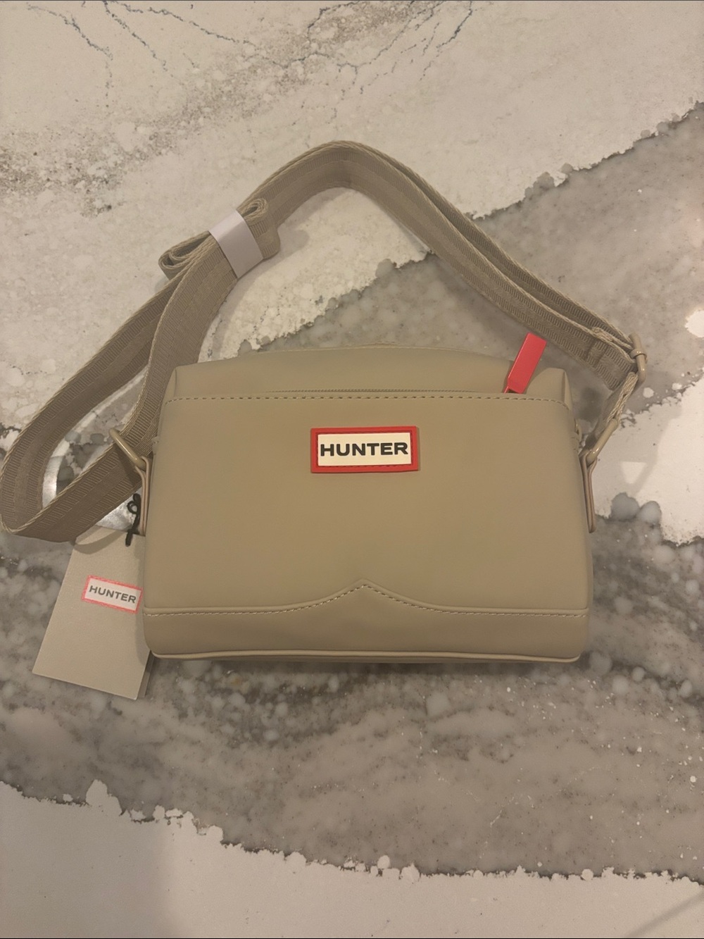Hunter Neutral Beige Crossbody Bag with Red Logo Accent